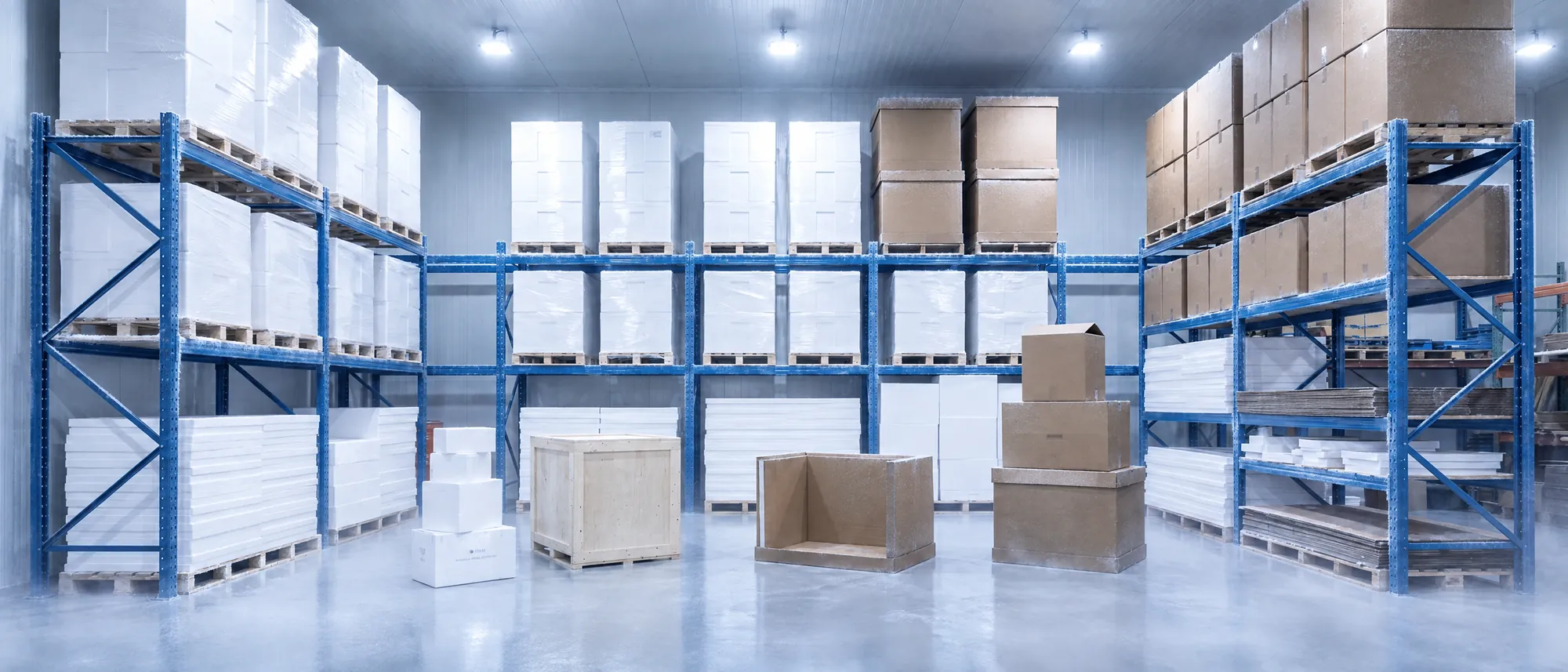 Organized Sub-Zero warehouse stocked with EPS foam insulated coolers and shipping cartons on pallet racking